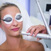 Female patient getting rf lifting procedure in a beauty saloon